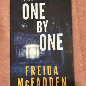 One by One by Freida McFadden - Dark Blue & Yellow Paperback Thriller